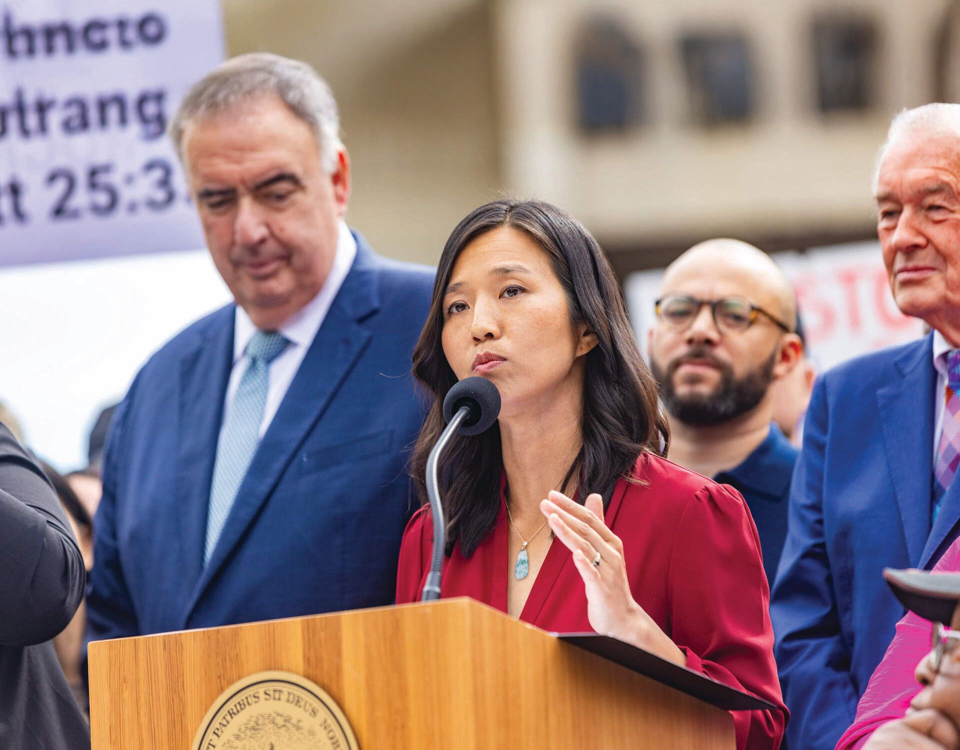 Boston Mayor Michelle Wu, joined by community members and elected officials, criticizes the Department of Justice during a press conference at City Hall Plaza last August. 